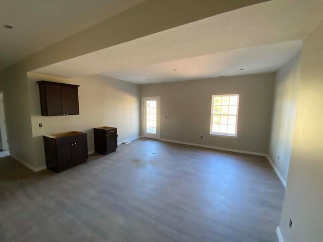 unfurnished living room featuring concrete floors