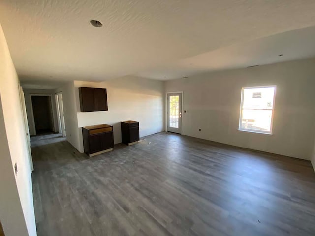 unfurnished living room with dark hardwood / wood-style floors