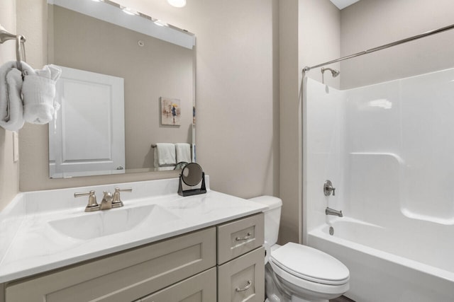 full bathroom featuring tub / shower combination, vanity, and toilet