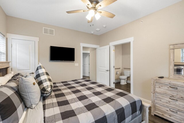 bedroom featuring ceiling fan, connected bathroom, and dark wood-type flooring