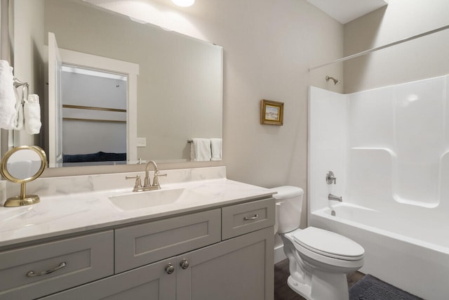 full bathroom with vanity, toilet, and washtub / shower combination