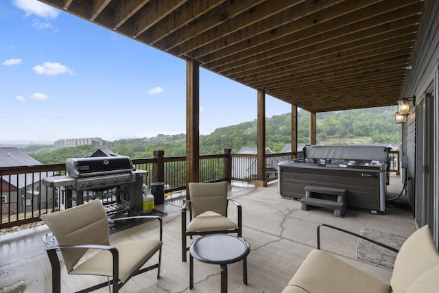 view of patio / terrace featuring a hot tub and grilling area