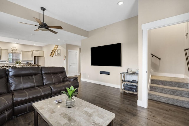 living room with ceiling fan and dark hardwood / wood-style flooring