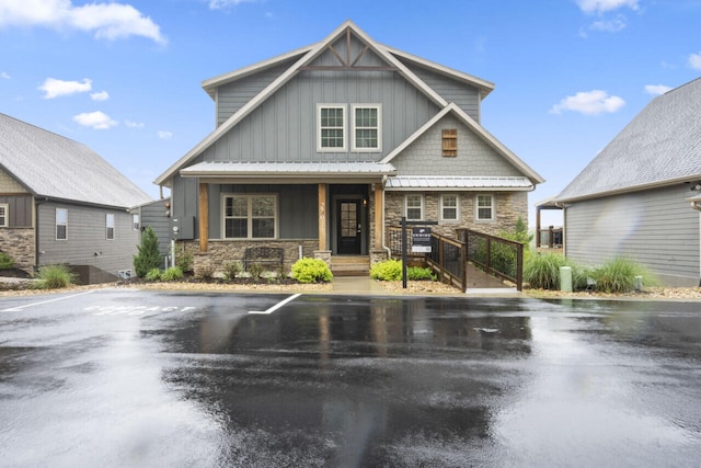 270 Chateau Cove Dr, Branson, MO 65616 - craftsman-style house featuring board and batten siding, a porch, stone siding, and uncovered parking