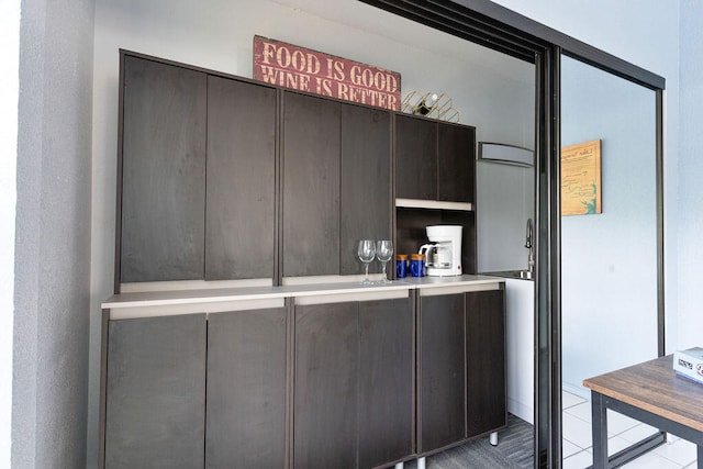 kitchen with dark brown cabinetry and tile patterned flooring