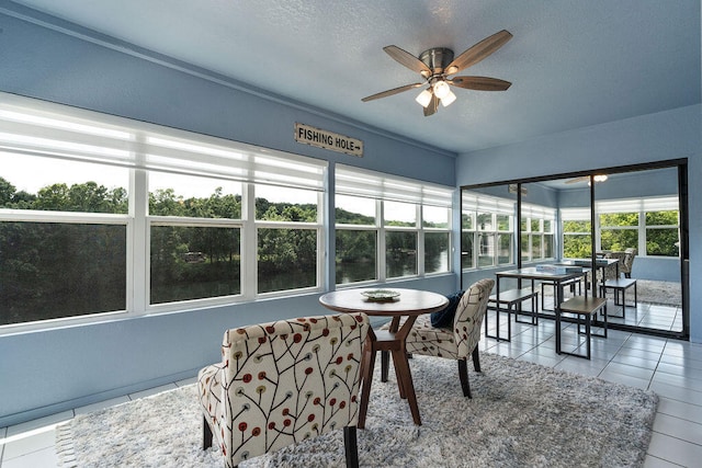 sunroom featuring ceiling fan