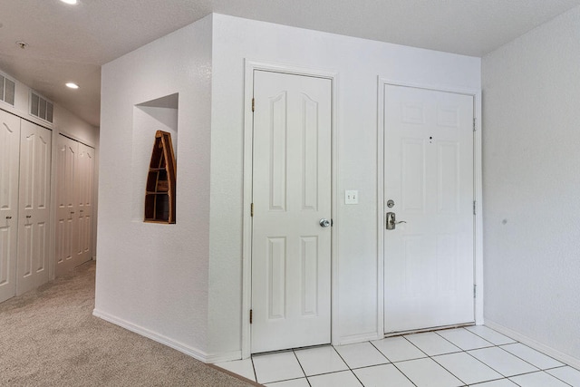 hallway featuring light colored carpet