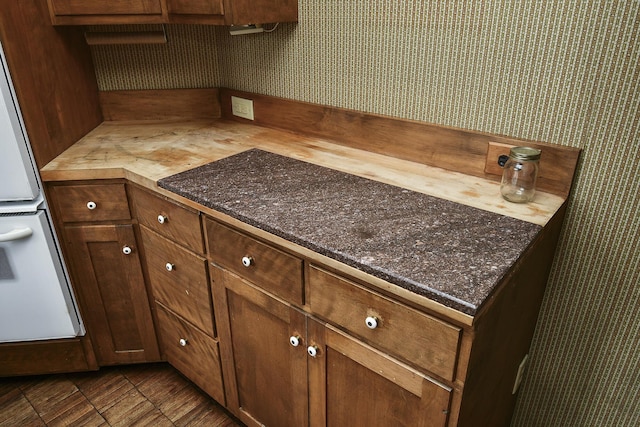 kitchen featuring white oven and wallpapered walls