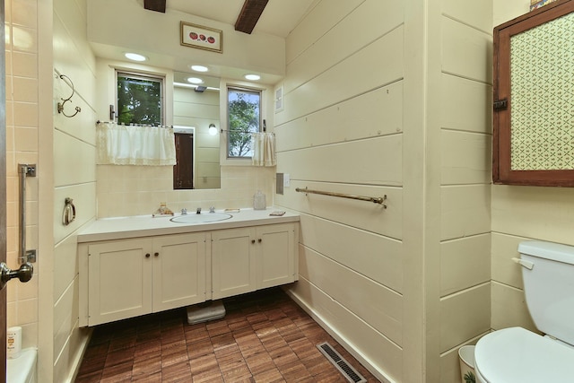 bathroom featuring visible vents, toilet, and vanity
