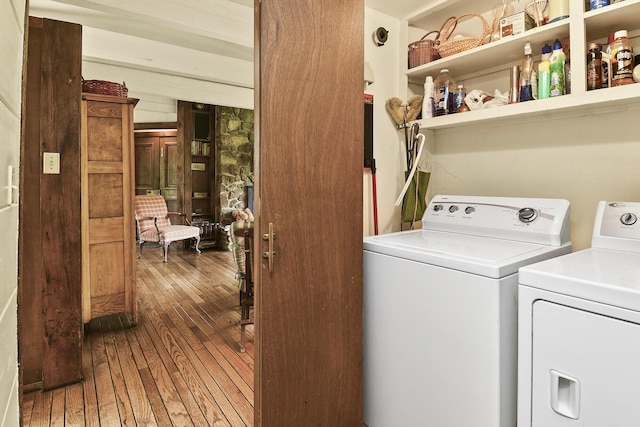 washroom featuring hardwood / wood-style floors, laundry area, and washer and clothes dryer
