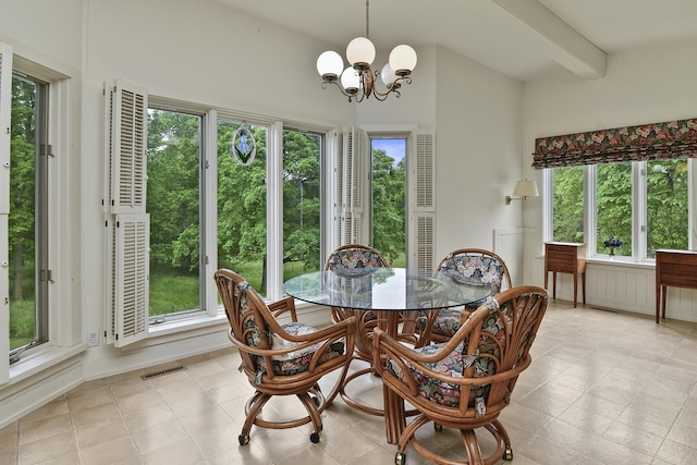 dining space with a notable chandelier, beamed ceiling, visible vents, and plenty of natural light