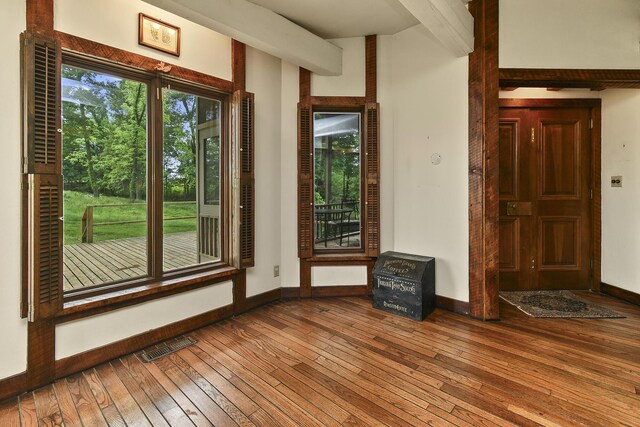 entryway with visible vents, hardwood / wood-style flooring, and baseboards