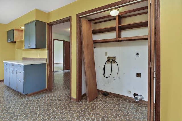 laundry room featuring electric dryer hookup, laundry area, and baseboards