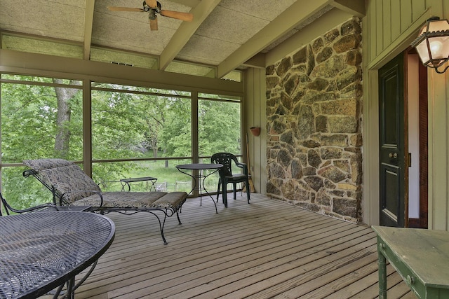 sunroom with beamed ceiling and ceiling fan