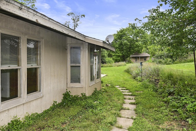 view of side of home with a lawn