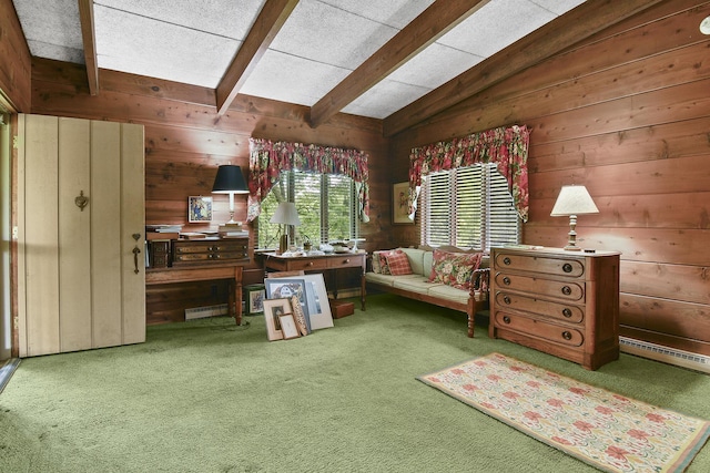 sitting room with wooden walls, carpet floors, and vaulted ceiling with beams