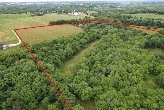 aerial view with a rural view and a wooded view