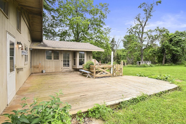wooden terrace featuring a yard