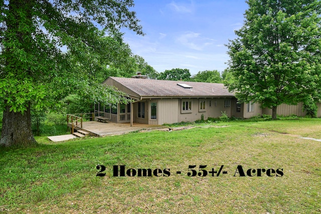 back of property with a yard and a patio area