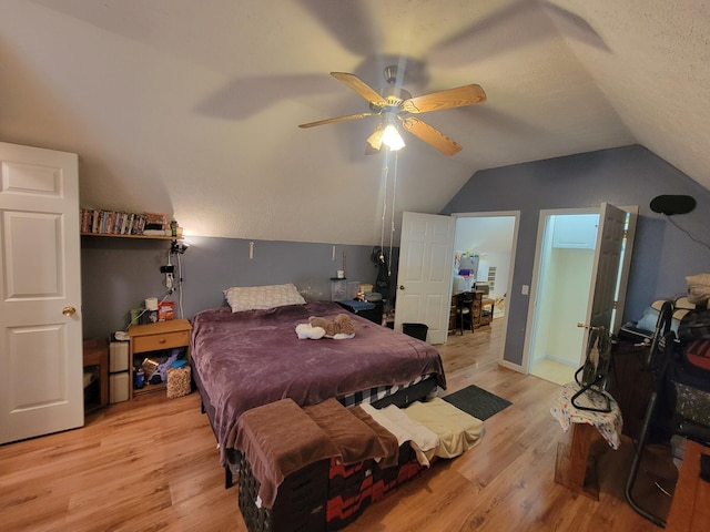 bedroom featuring ceiling fan, a textured ceiling, light hardwood / wood-style flooring, and vaulted ceiling