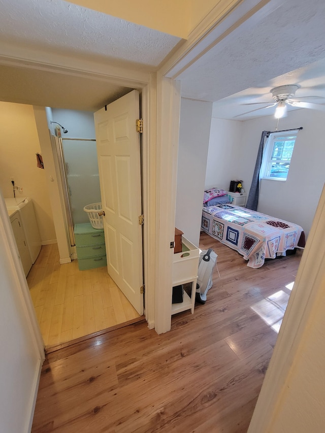 bedroom with wood-type flooring, a textured ceiling, and ceiling fan