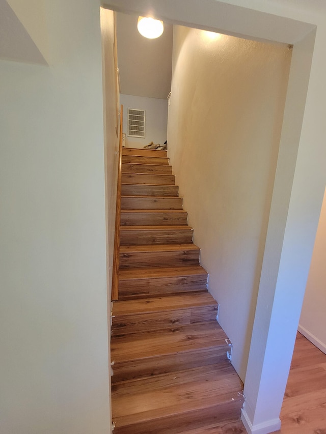 stairway featuring wood-type flooring