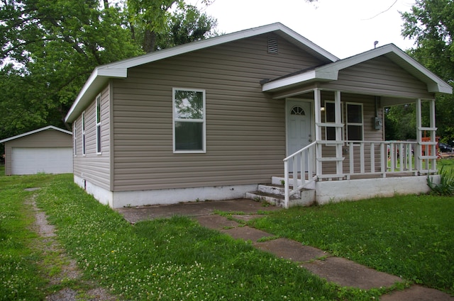 bungalow-style house with a front lawn and covered porch