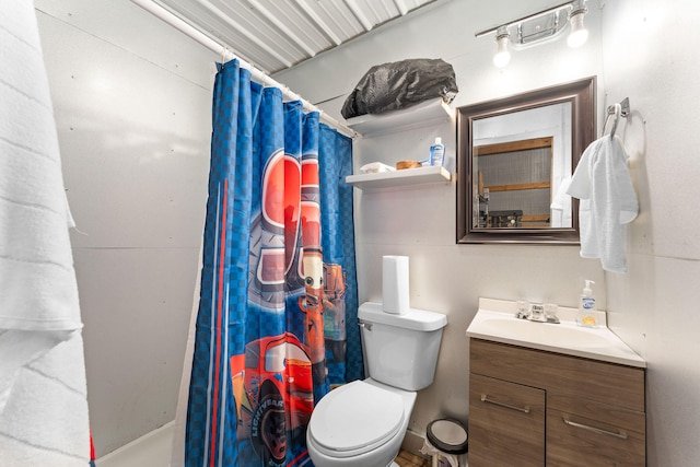 bathroom featuring vanity, toilet, and curtained shower