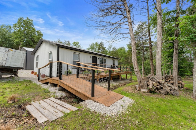 rear view of house featuring a deck