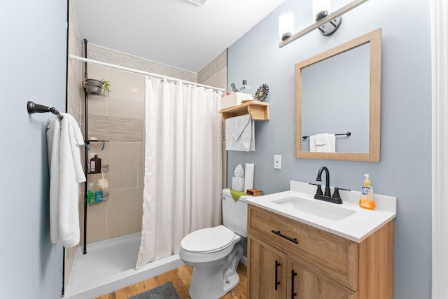 bathroom with a shower with shower curtain, vanity, and toilet