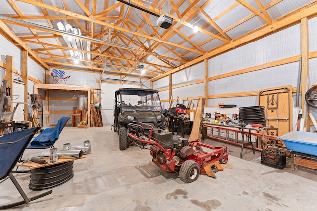 garage with a garage door opener and a workshop area