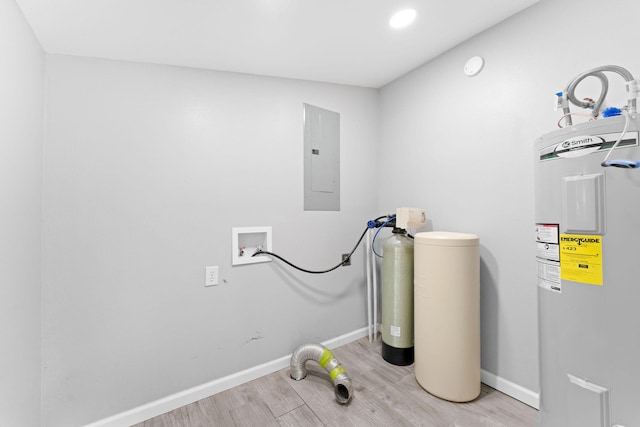 utility room featuring electric panel and electric water heater