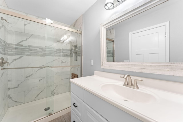 bathroom featuring vanity and a shower with shower door