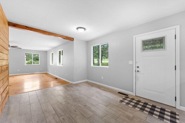 foyer entrance with light wood-type flooring, a wealth of natural light, and ceiling fan