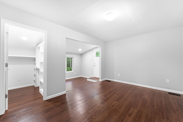 spare room with dark wood-type flooring