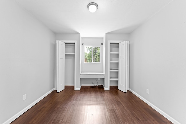 unfurnished bedroom with dark wood-type flooring