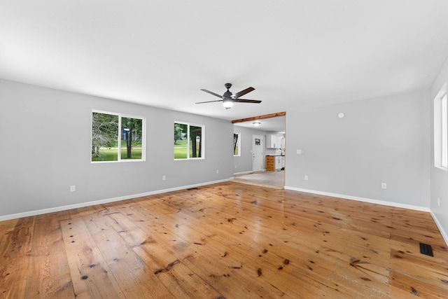 unfurnished living room with light wood-type flooring and ceiling fan