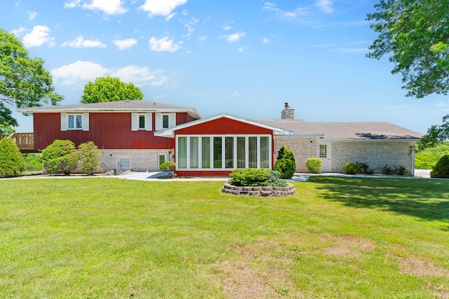 rear view of property with a yard and a patio area