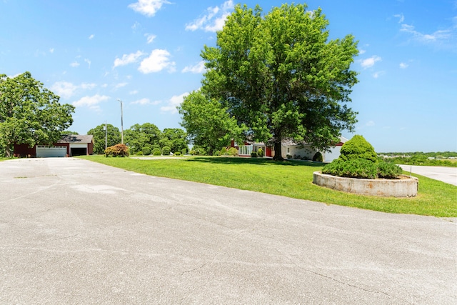 view of front of house featuring a garage and a front lawn