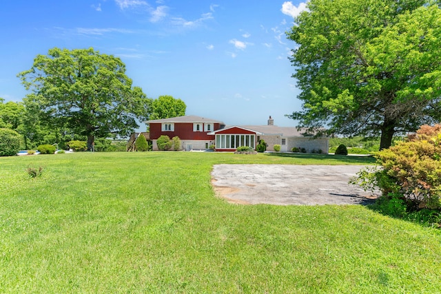 view of yard with a sunroom