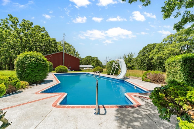 view of pool with a patio and a water slide