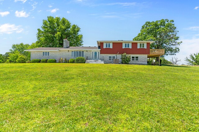 back of house with a lawn