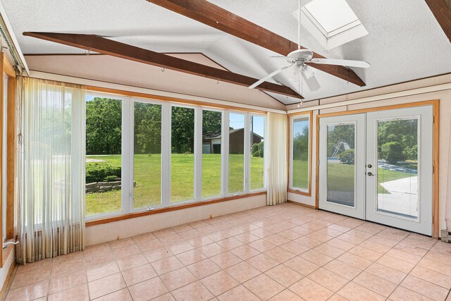 unfurnished sunroom featuring french doors, vaulted ceiling with skylight, and ceiling fan