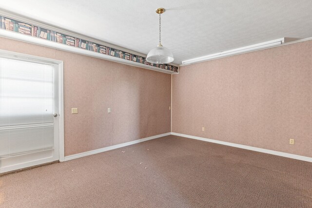 carpeted empty room featuring a textured ceiling