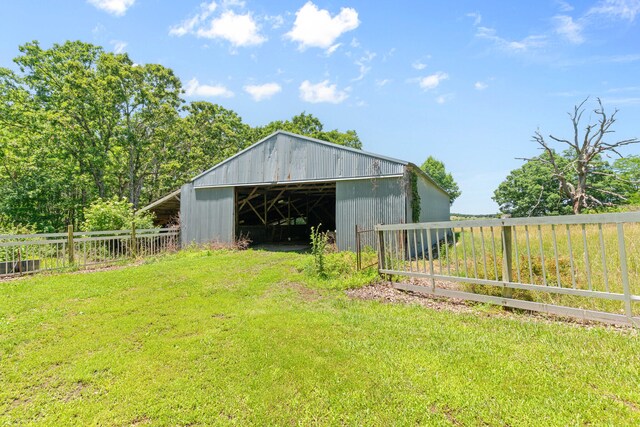 view of outbuilding with a yard