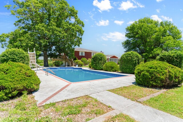 view of swimming pool featuring a water slide