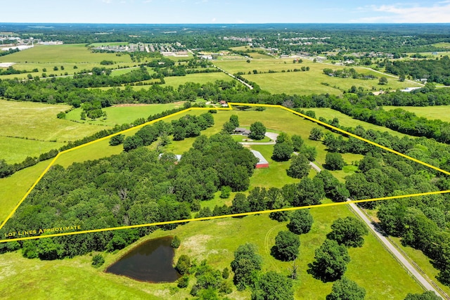 birds eye view of property featuring a water view and a rural view