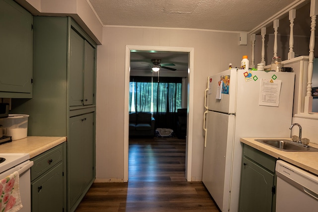 kitchen featuring dark hardwood / wood-style floors, white appliances, sink, ornamental molding, and a textured ceiling