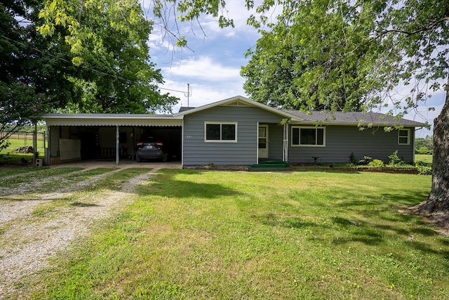 view of front facade with a front yard and a carport