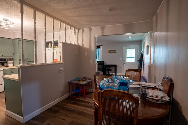 dining space with hardwood / wood-style floors and a textured ceiling